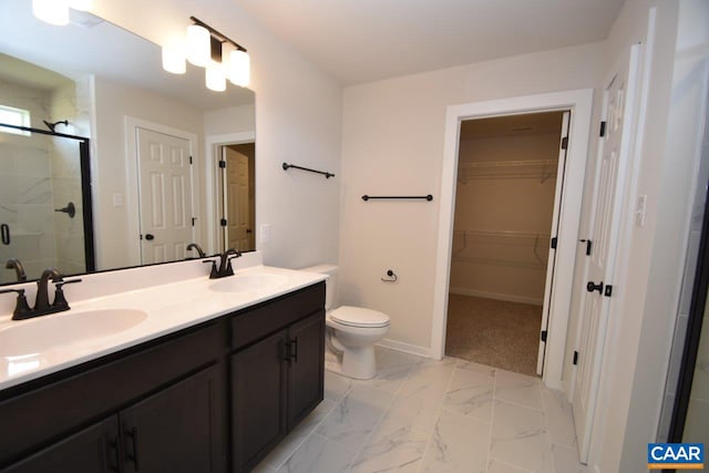 bathroom featuring a shower with shower door, toilet, and vanity