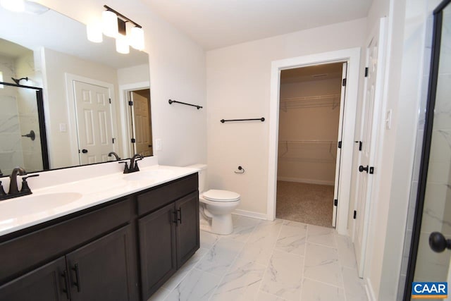 bathroom with toilet, a shower with door, and vanity