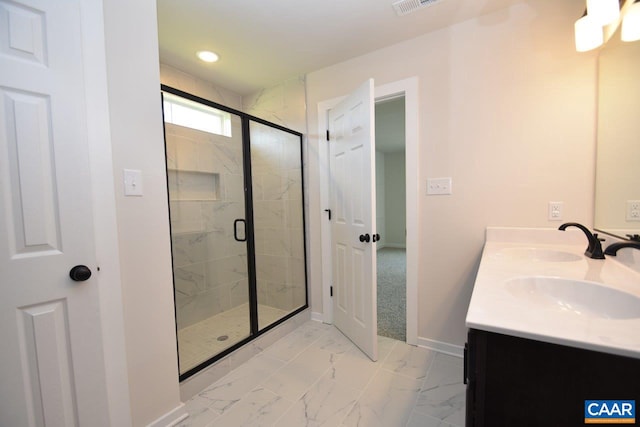 bathroom with a shower with door and vanity