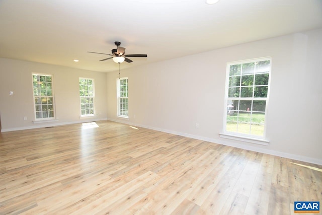 empty room featuring ceiling fan and light hardwood / wood-style flooring