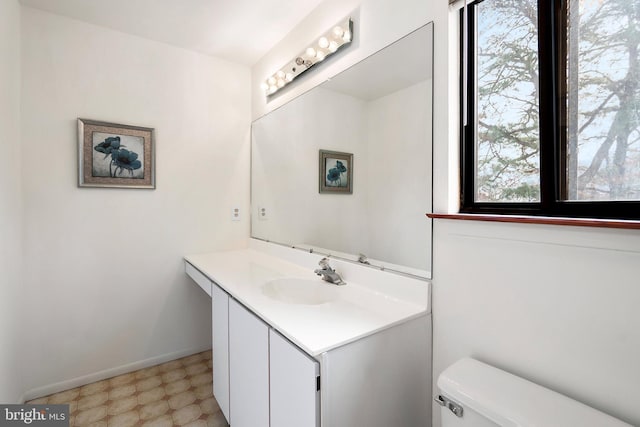 bathroom featuring vanity and toilet