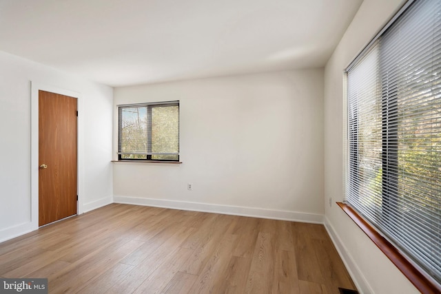 empty room with light hardwood / wood-style flooring