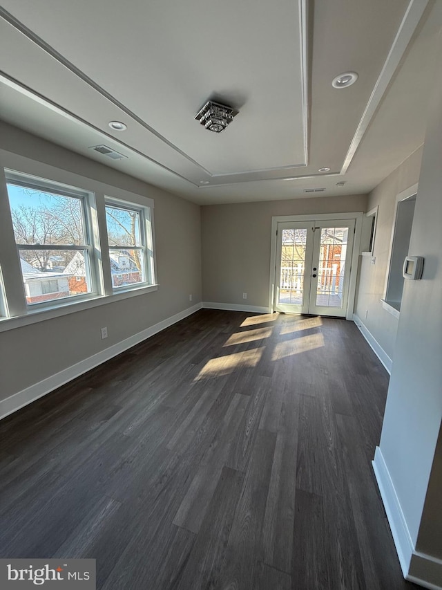 spare room with dark hardwood / wood-style flooring and french doors