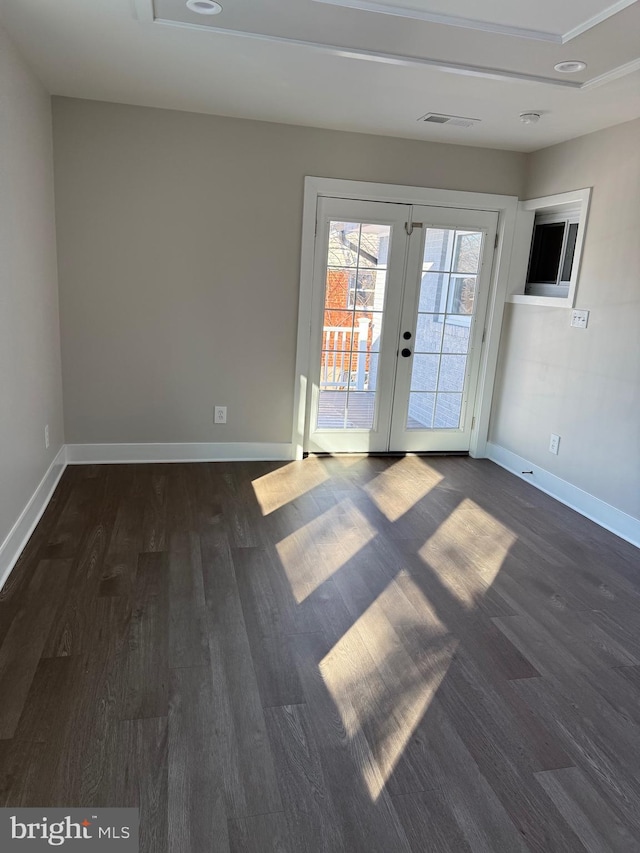 unfurnished room with dark wood-type flooring and french doors