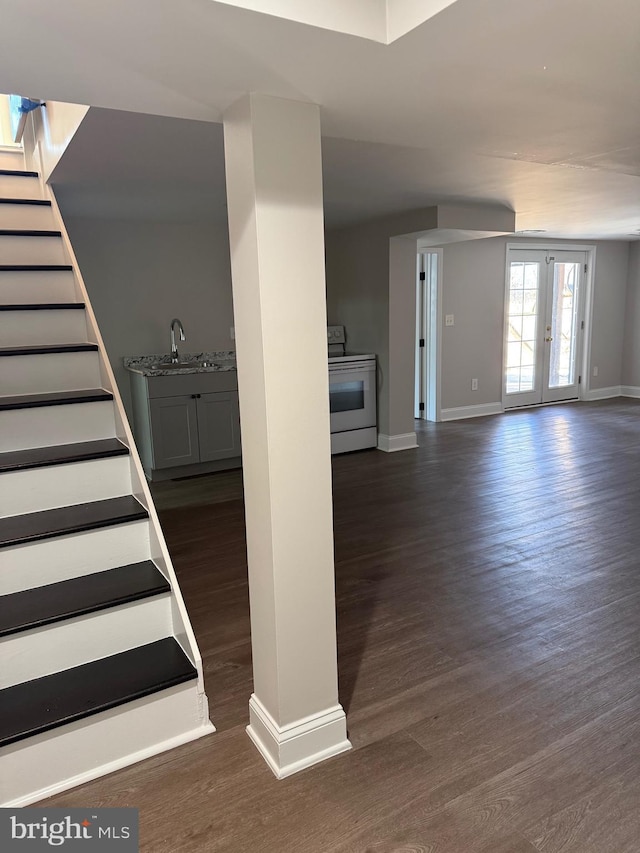 stairs featuring sink, hardwood / wood-style floors, and french doors