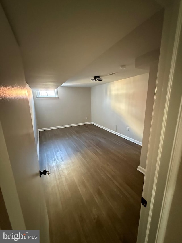 empty room featuring dark hardwood / wood-style flooring