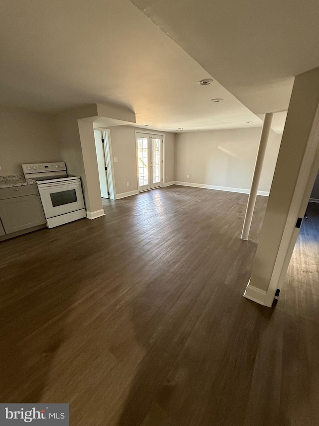 unfurnished living room with dark hardwood / wood-style flooring and french doors