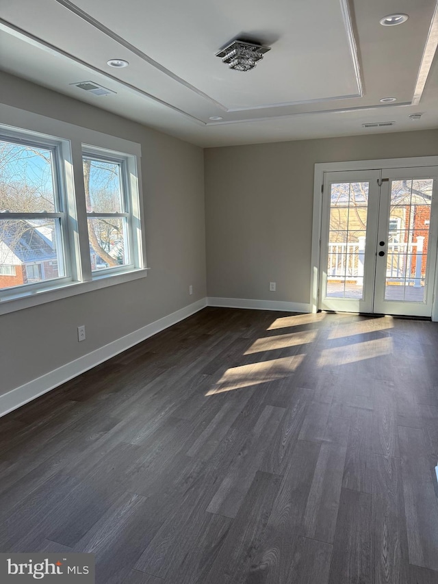 empty room with dark hardwood / wood-style floors and french doors