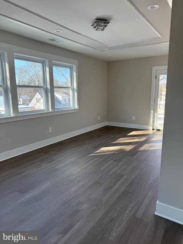 unfurnished room with dark hardwood / wood-style flooring