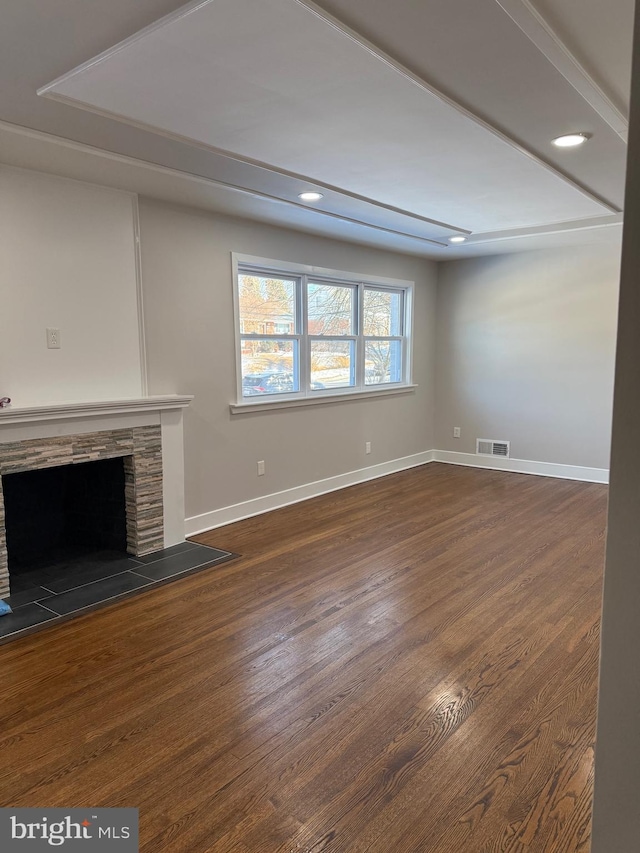 unfurnished living room with dark hardwood / wood-style flooring and a fireplace