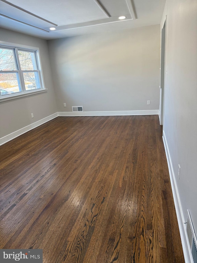 spare room with dark hardwood / wood-style flooring