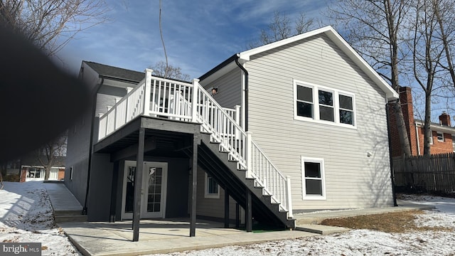 snow covered property featuring a patio