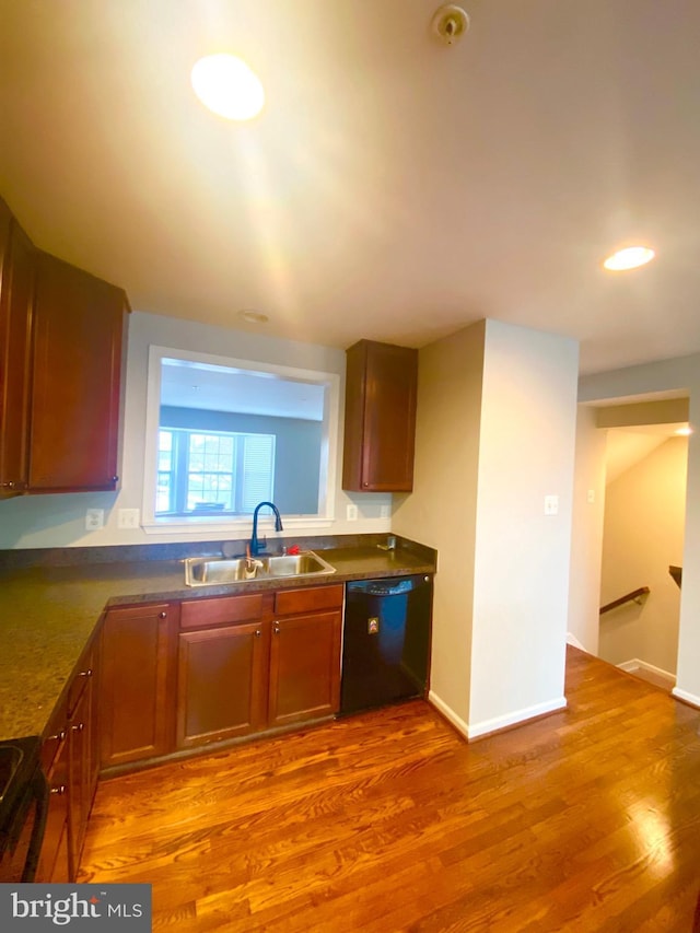 kitchen with sink, black appliances, and light wood-type flooring