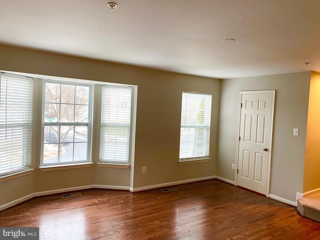 spare room featuring dark hardwood / wood-style floors