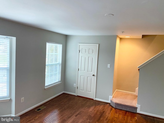 interior space with dark wood-type flooring and a healthy amount of sunlight