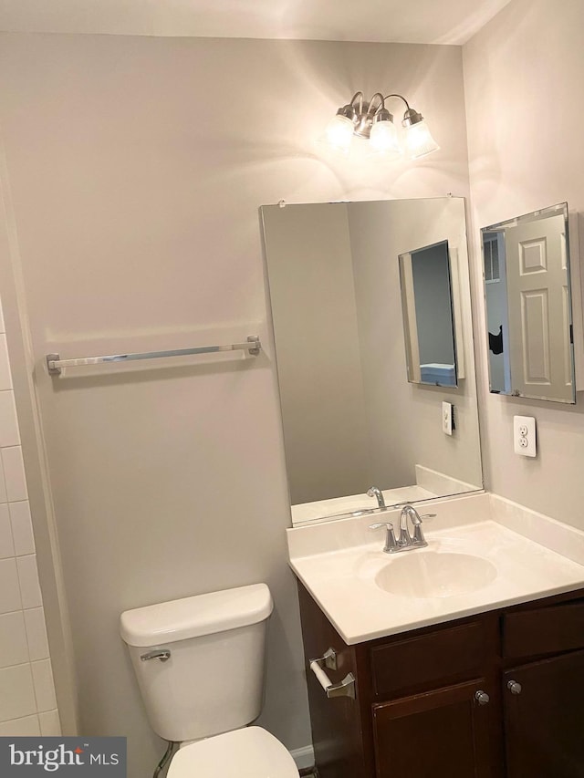 bathroom featuring vanity and toilet