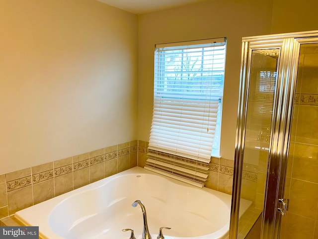 bathroom with shower with separate bathtub