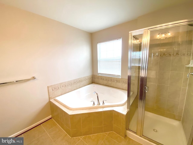 bathroom featuring tile patterned flooring and shower with separate bathtub