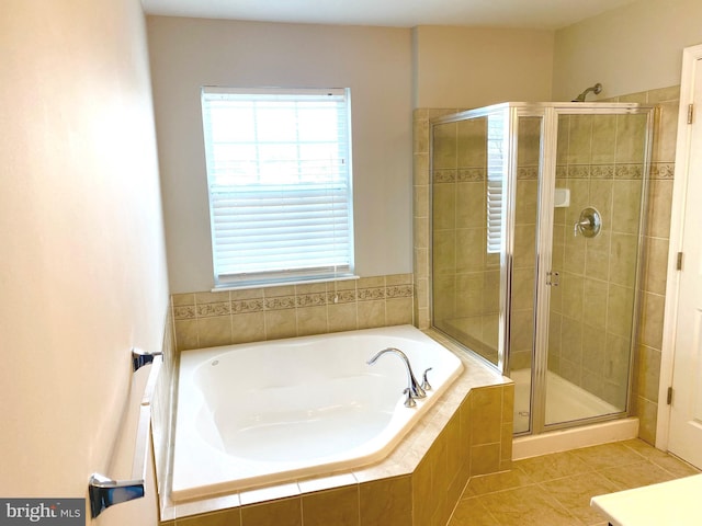 bathroom with tile patterned floors and shower with separate bathtub