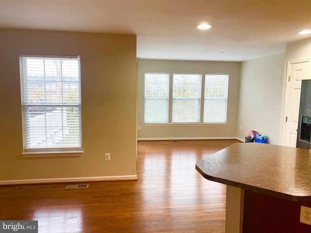 unfurnished living room featuring wood-type flooring