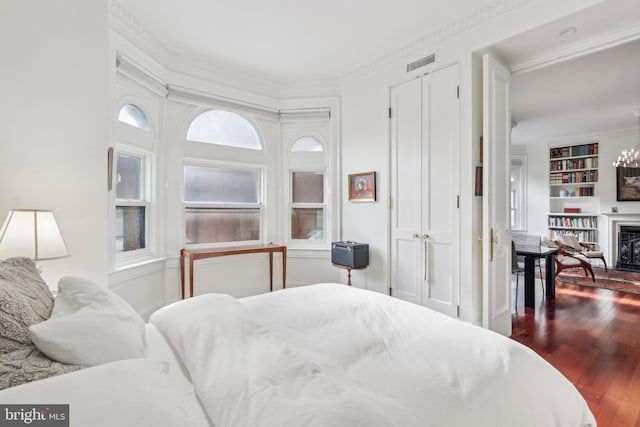 bedroom featuring dark wood-type flooring and multiple windows