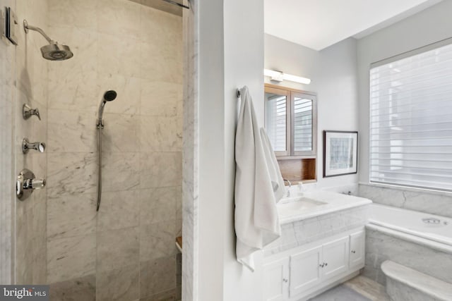 bathroom featuring shower with separate bathtub and vanity