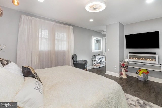 bedroom featuring recessed lighting, dark wood finished floors, and baseboards