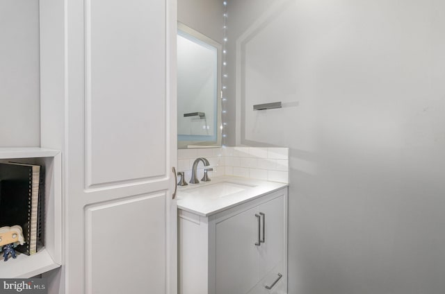 bathroom with tasteful backsplash and vanity