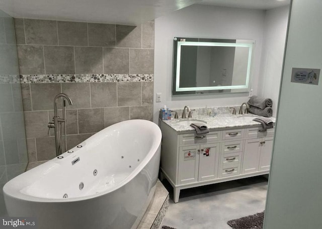 full bathroom featuring a freestanding bath, double vanity, a sink, and tile walls