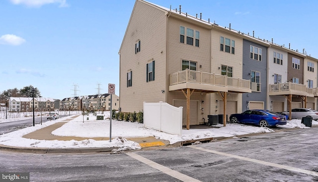 snow covered property featuring cooling unit