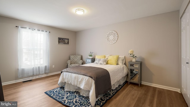 bedroom featuring hardwood / wood-style flooring and a closet