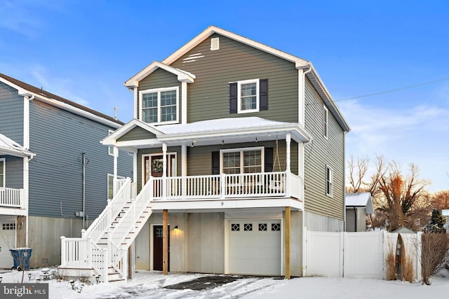 view of front of home featuring covered porch and a garage