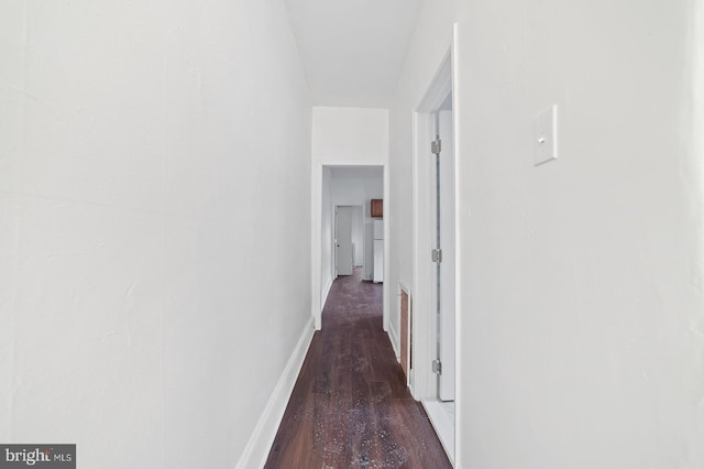 hallway with dark hardwood / wood-style floors