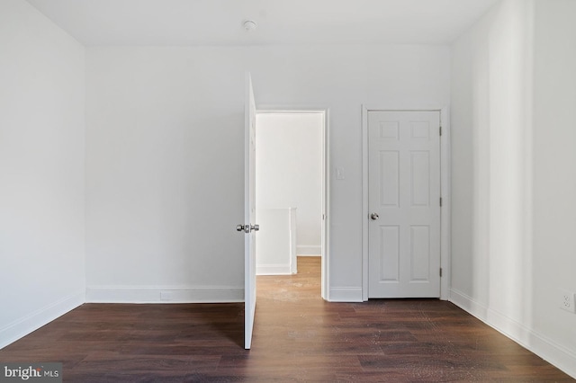 unfurnished bedroom featuring dark wood-type flooring