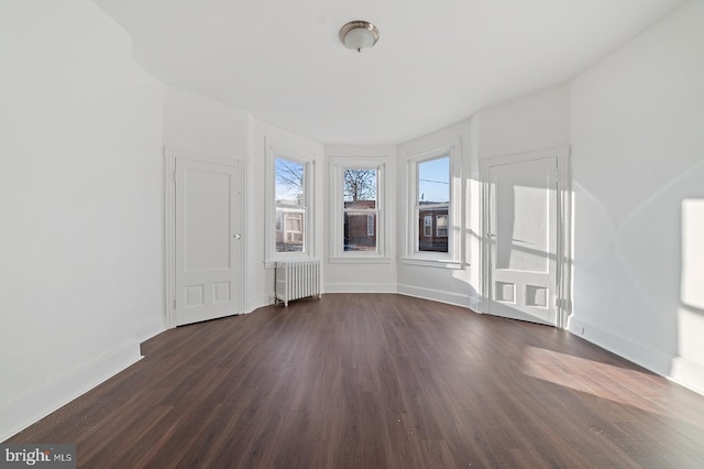 interior space featuring radiator heating unit and dark hardwood / wood-style floors