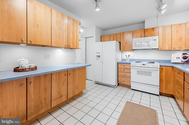 kitchen featuring white appliances, rail lighting, light countertops, and brown cabinetry