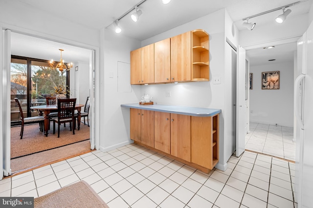 kitchen with light tile patterned floors, a notable chandelier, hanging light fixtures, light countertops, and open shelves