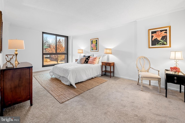 bedroom with light carpet, crown molding, and baseboards