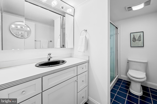 bathroom with toilet, a stall shower, vanity, tile patterned flooring, and baseboards