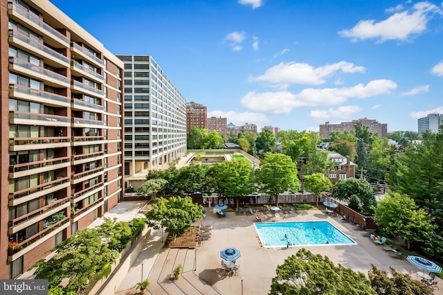 pool with a view of city and a patio area