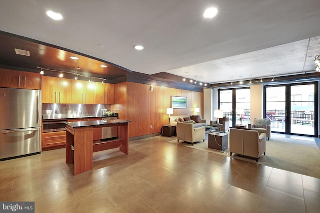 kitchen featuring track lighting, french doors, and stainless steel fridge