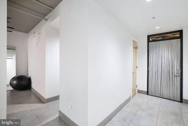 hall featuring light tile patterned flooring