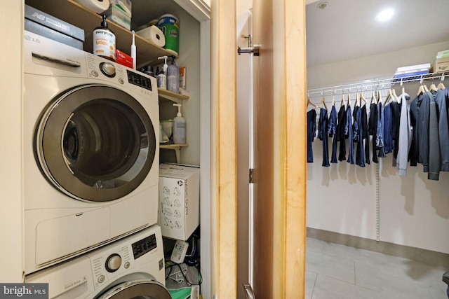 washroom with stacked washing maching and dryer