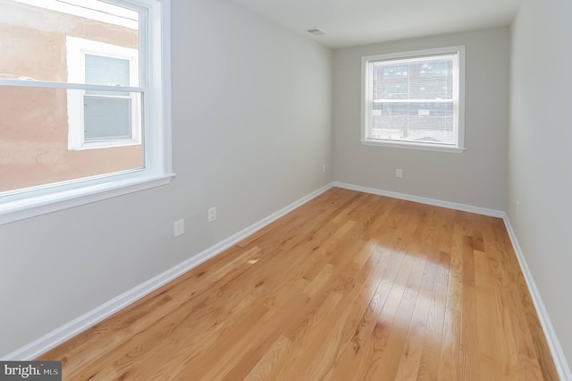 spare room with light hardwood / wood-style floors