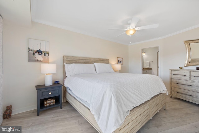 bedroom featuring ornamental molding, ensuite bathroom, and light hardwood / wood-style flooring