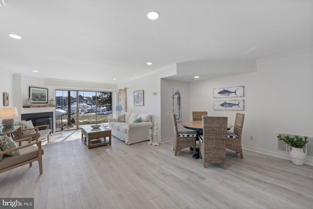 living room with crown molding and light wood-type flooring