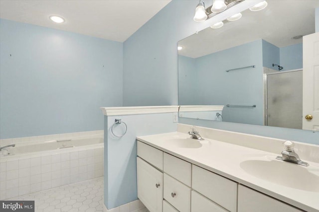 bathroom featuring a stall shower, a garden tub, a sink, and tile patterned floors