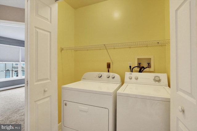 laundry area featuring washer and dryer, laundry area, and carpet