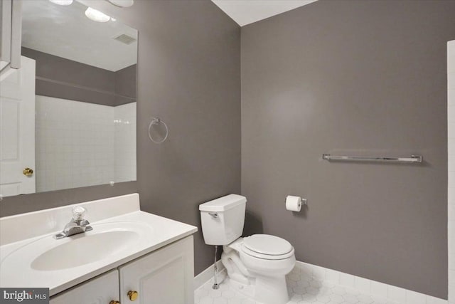 bathroom featuring toilet, baseboards, visible vents, and vanity