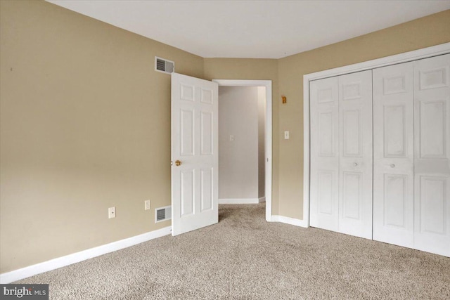 unfurnished bedroom featuring a closet, baseboards, visible vents, and carpet flooring